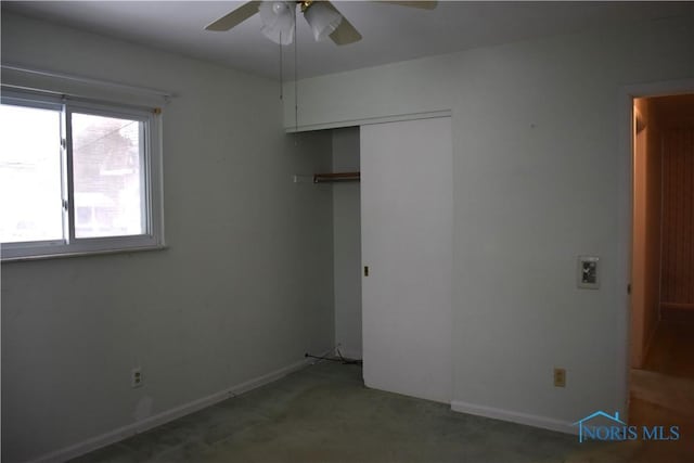 unfurnished bedroom featuring ceiling fan, carpet floors, and a closet