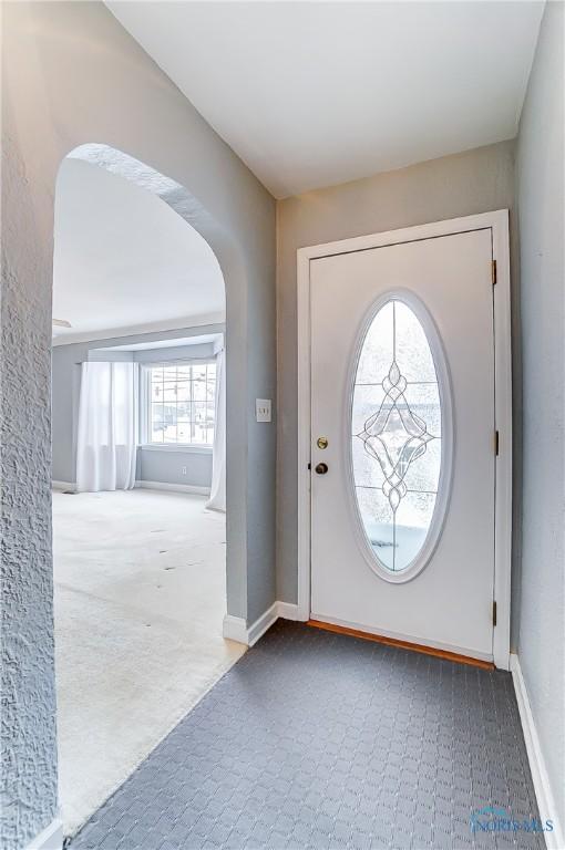 view of carpeted foyer entrance