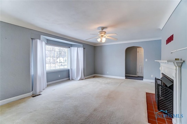 unfurnished living room featuring carpet flooring and ceiling fan