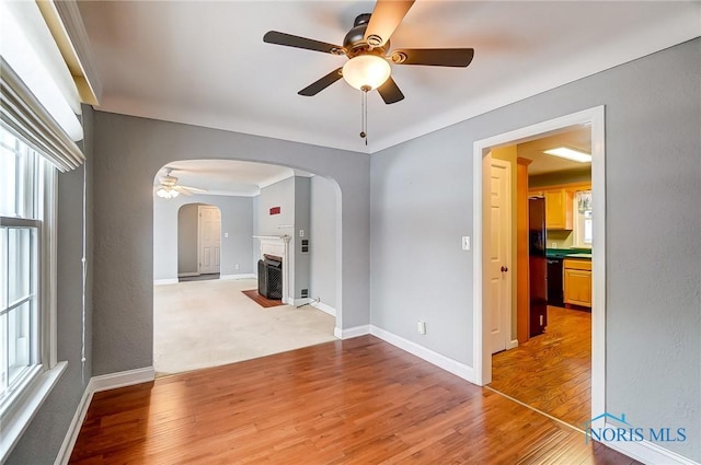 empty room with hardwood / wood-style flooring and ceiling fan