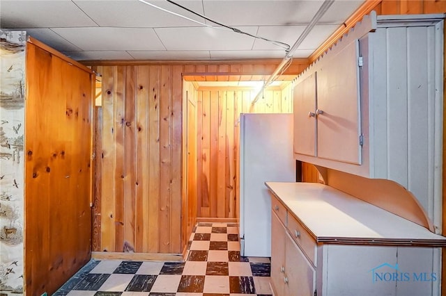 interior space with wooden walls and refrigerator