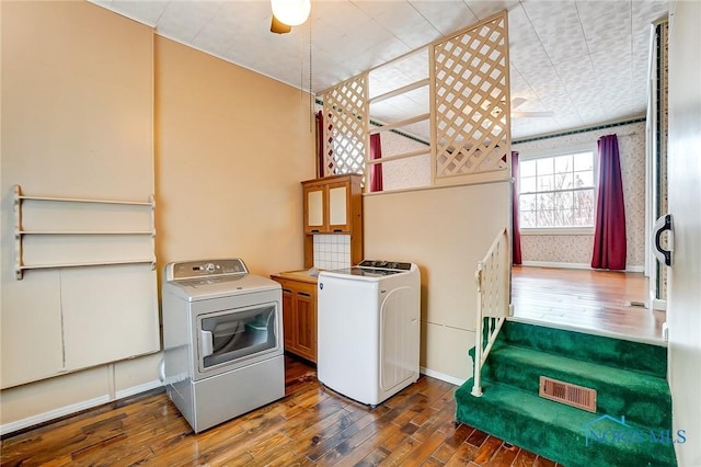 washroom featuring cabinets, washer / dryer, and dark wood-type flooring