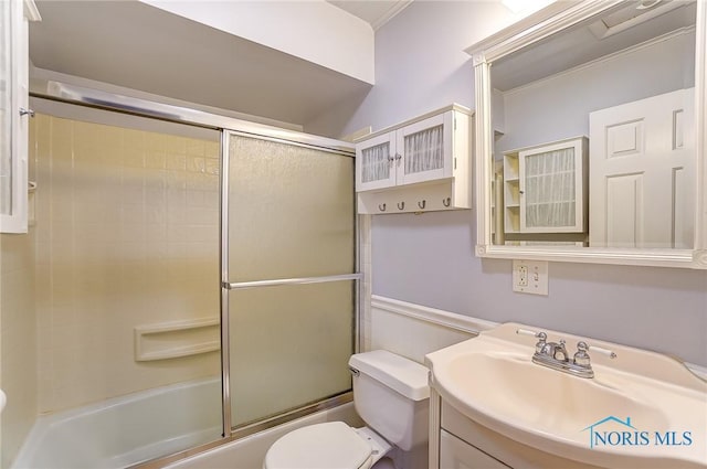 full bathroom with vanity, shower / bath combination with glass door, and toilet