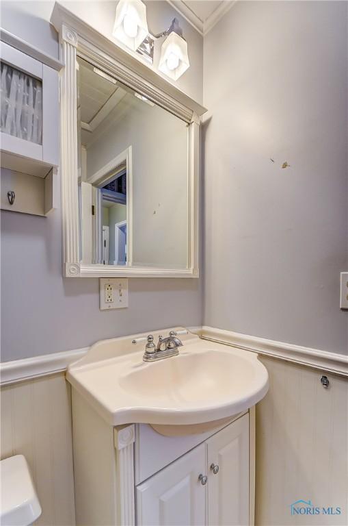 bathroom featuring crown molding and vanity