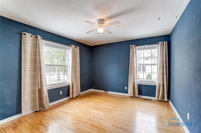 unfurnished room featuring ceiling fan, plenty of natural light, and hardwood / wood-style floors