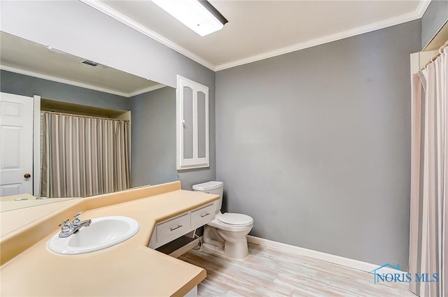 bathroom with walk in shower, toilet, ornamental molding, vanity, and hardwood / wood-style floors