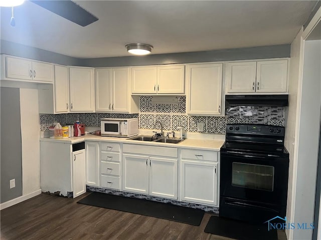 kitchen featuring sink, dark wood-type flooring, white cabinetry, tasteful backsplash, and black electric range