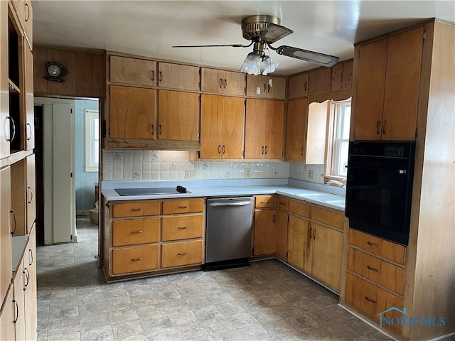 kitchen featuring sink, decorative backsplash, black appliances, and ceiling fan