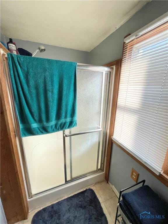 bathroom with tile patterned flooring and an enclosed shower