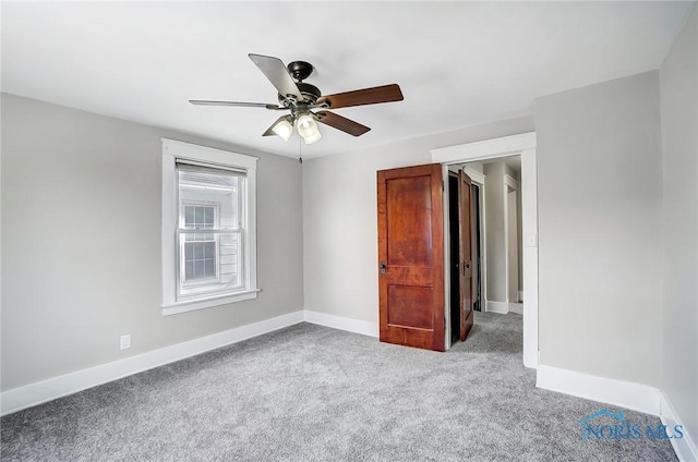 empty room with ceiling fan and light carpet