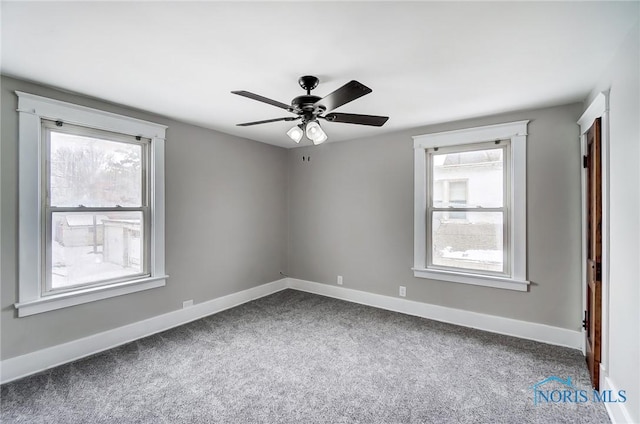 carpeted empty room featuring ceiling fan