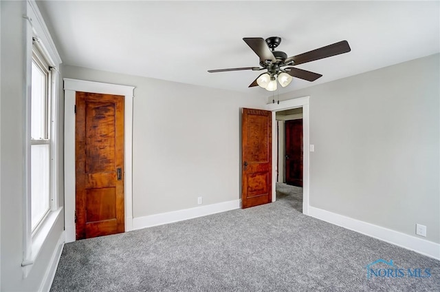 unfurnished bedroom with a closet, ceiling fan, and carpet