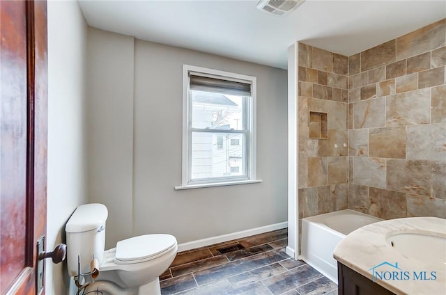 full bathroom featuring vanity, tub / shower combination, and toilet