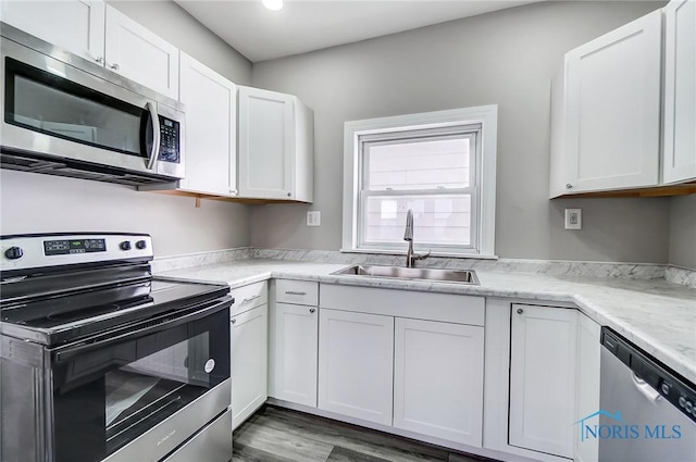 kitchen with white cabinetry, appliances with stainless steel finishes, and sink