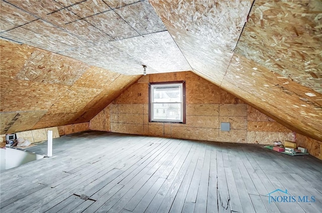 bonus room with lofted ceiling and hardwood / wood-style floors