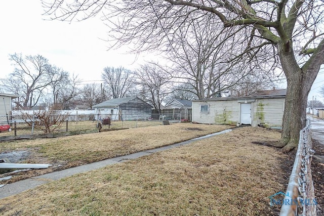 view of yard featuring an outbuilding and fence