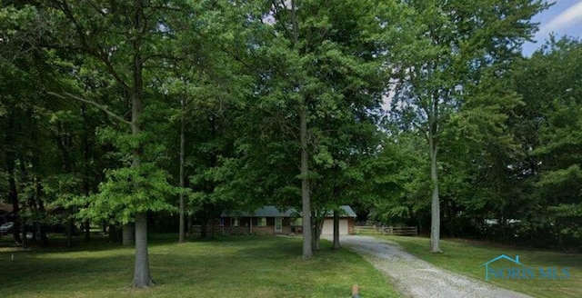 view of front of home with a garage and a front lawn