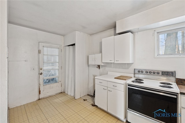 kitchen featuring white cabinetry and white range with electric cooktop