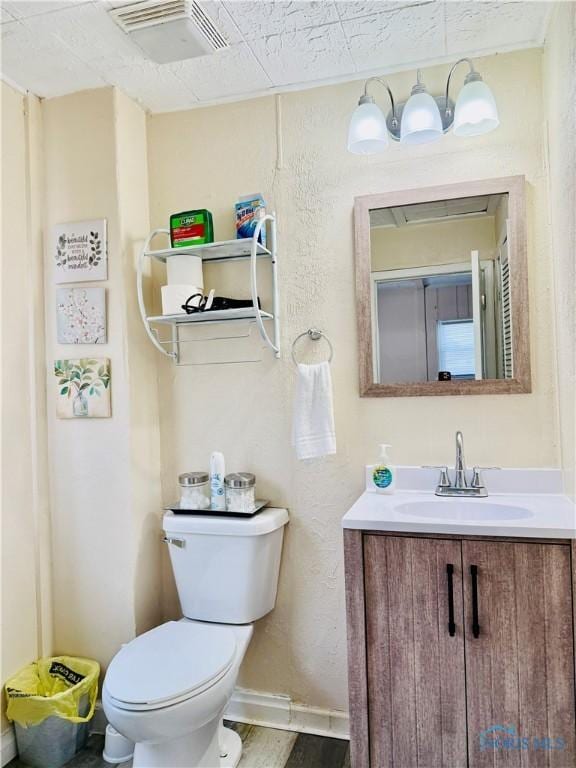 bathroom with vanity, hardwood / wood-style flooring, and toilet