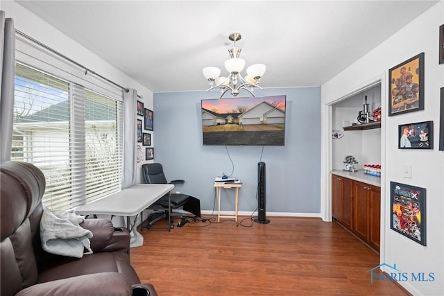 living area with a notable chandelier and dark wood-type flooring