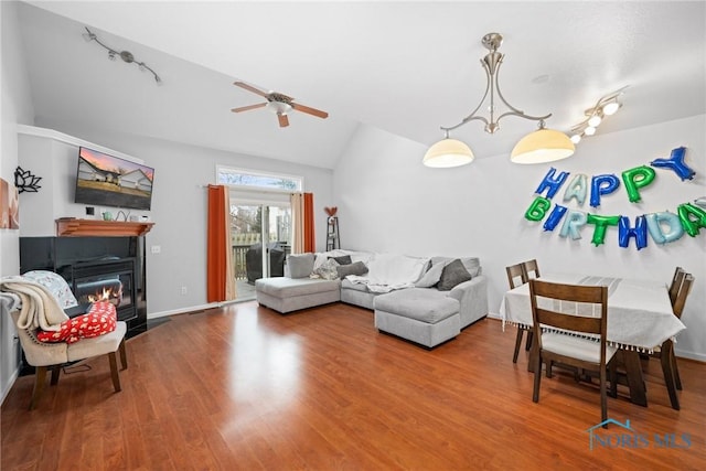 living room with vaulted ceiling, ceiling fan, and hardwood / wood-style floors