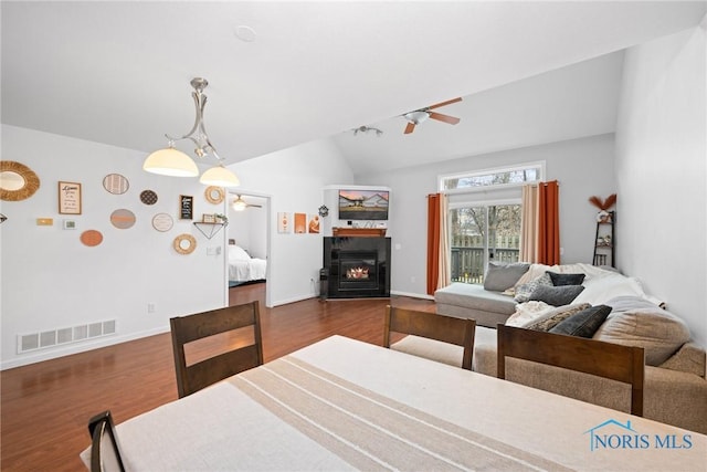 interior space featuring lofted ceiling and dark wood-type flooring