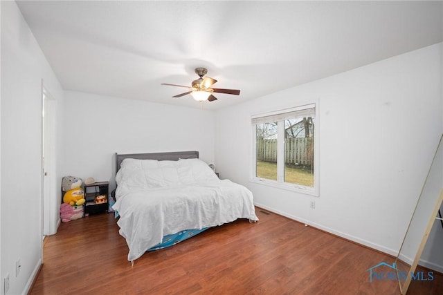 bedroom featuring dark hardwood / wood-style floors and ceiling fan