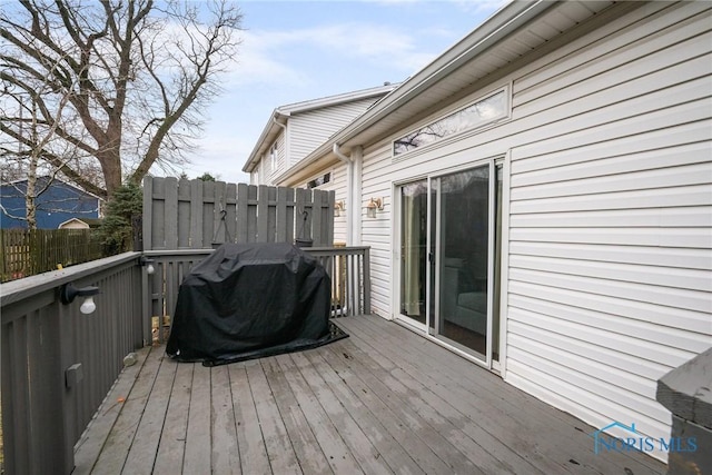 wooden deck with a grill