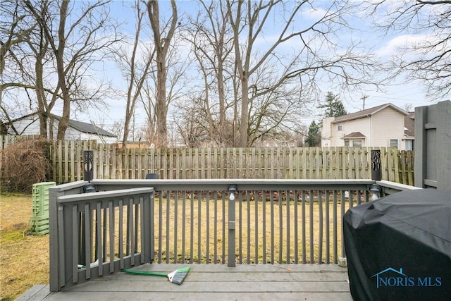 deck with grilling area and a lawn