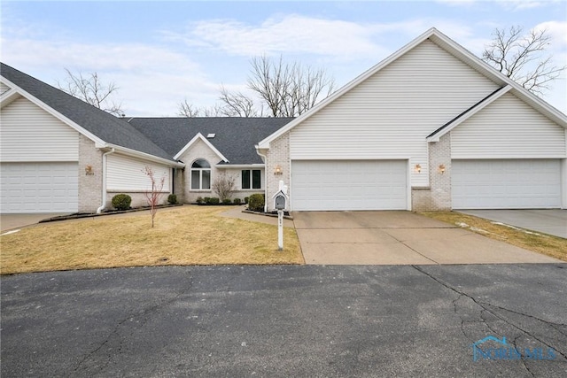 ranch-style house featuring a garage and a front lawn