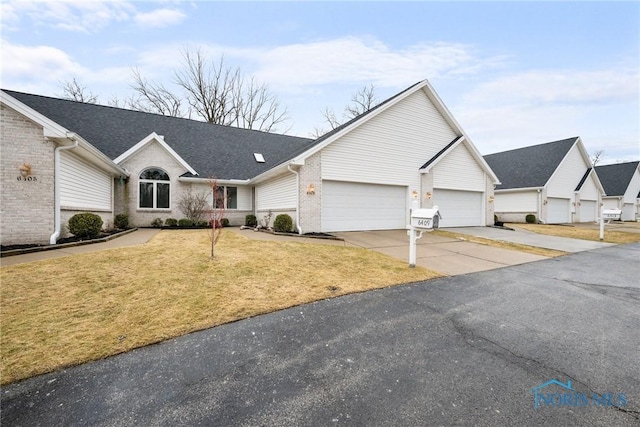 single story home with a garage and a front yard