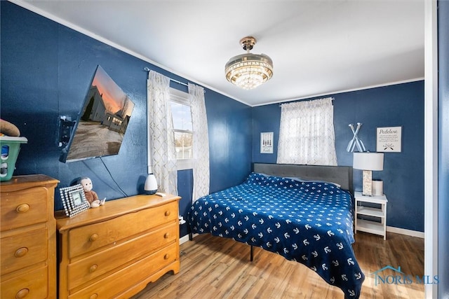 bedroom with crown molding and wood-type flooring