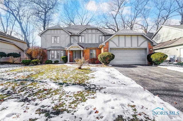 tudor-style house featuring a garage