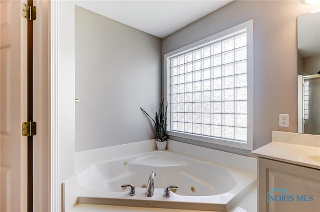 bathroom with vanity and a bathtub