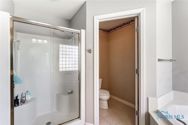 bathroom with tile patterned flooring, independent shower and bath, and toilet