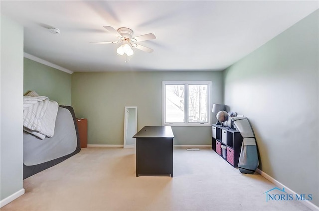 carpeted home office featuring ceiling fan