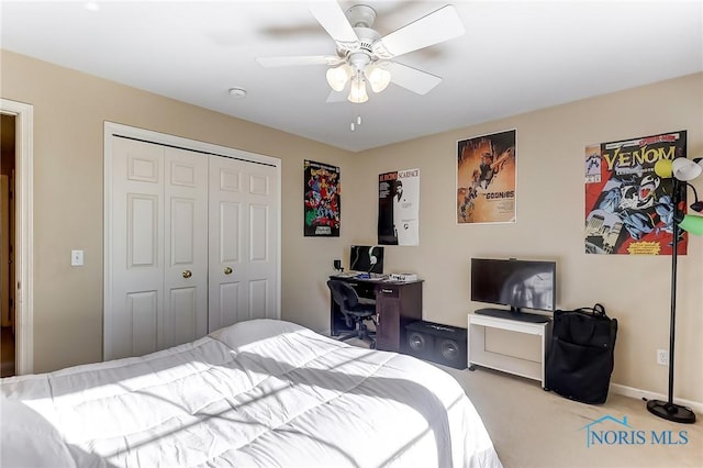 bedroom featuring light colored carpet, a closet, and ceiling fan