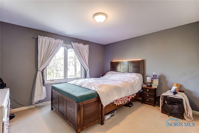 bedroom featuring light colored carpet