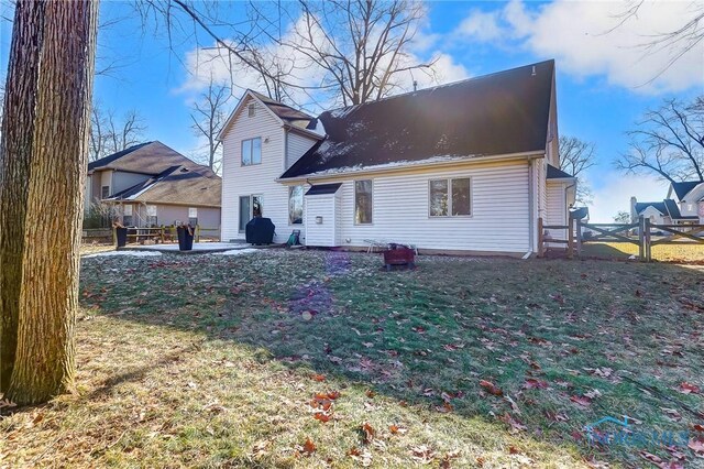 back of property with a patio area and a lawn