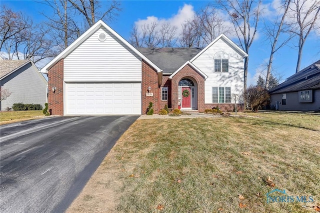 view of front of property featuring a garage and a front lawn