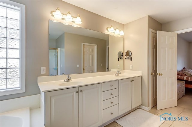 bathroom featuring tile patterned flooring and vanity