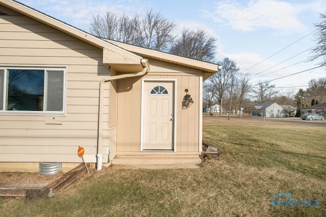 entrance to property with a yard