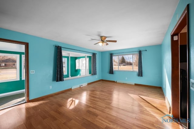 unfurnished room featuring ceiling fan and hardwood / wood-style floors