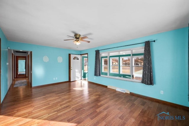 spare room featuring hardwood / wood-style flooring and ceiling fan