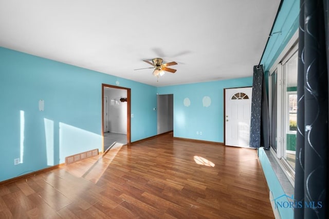 spare room featuring hardwood / wood-style floors and ceiling fan