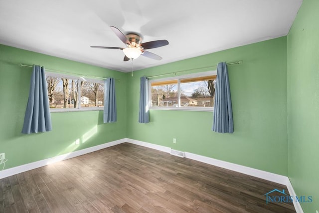 unfurnished room featuring hardwood / wood-style floors and ceiling fan