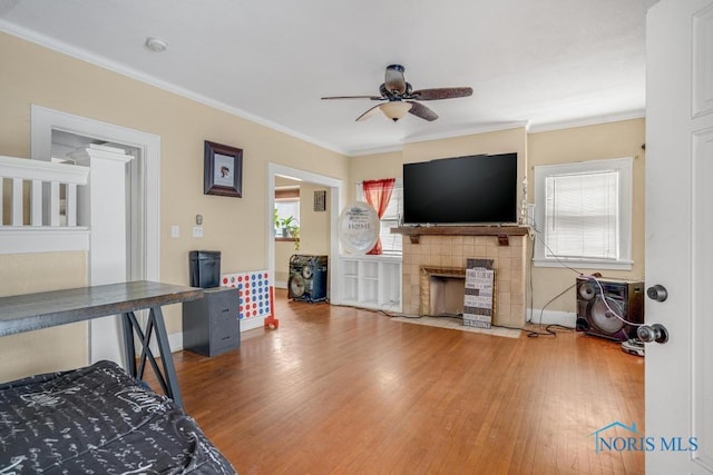 interior space featuring ceiling fan, ornamental molding, hardwood / wood-style floors, and a wealth of natural light