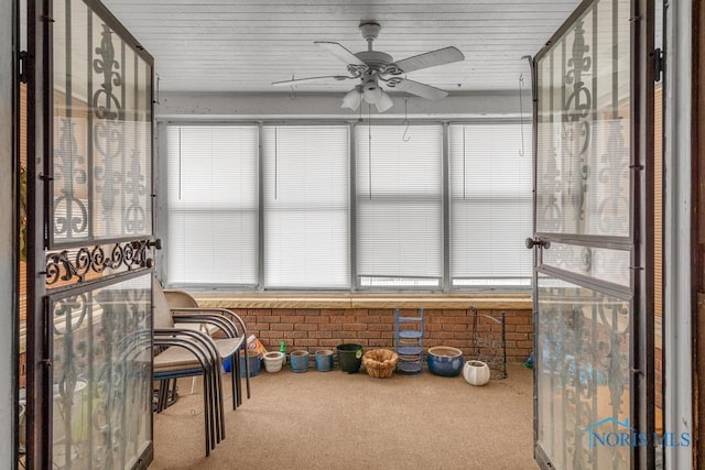 sunroom / solarium featuring ceiling fan