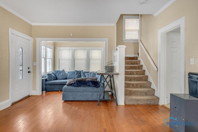 entrance foyer featuring hardwood / wood-style flooring and ornamental molding