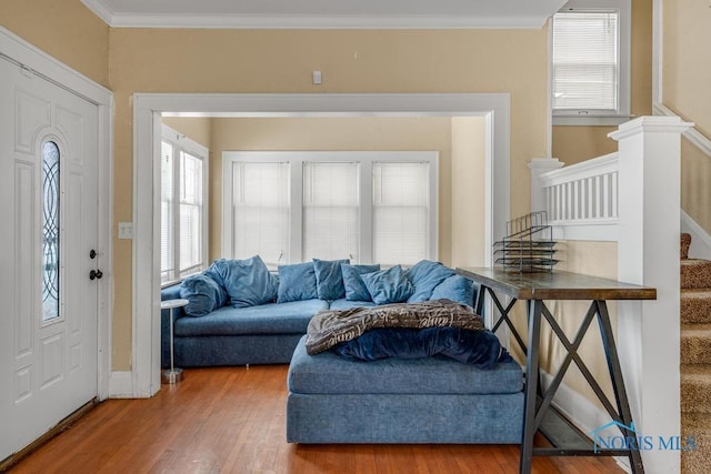 interior space featuring crown molding, wood-type flooring, and plenty of natural light